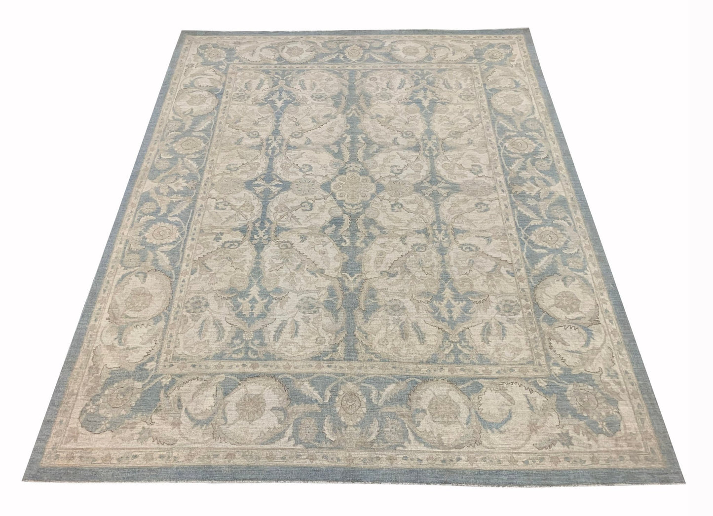 Handmade Afghan Chobi rug featuring a traditional floral pattern in shades of blue and beige.