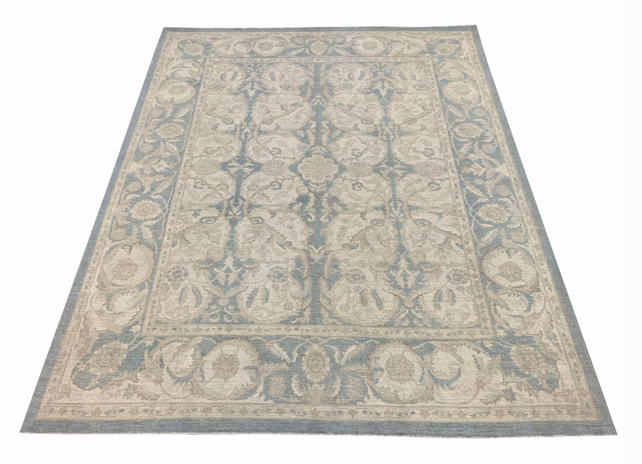 Handmade Afghan Chobi rug featuring a traditional floral pattern in shades of blue and beige.