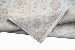 A handwoven Afghan Chobi rug featuring a traditional floral pattern in soft, earthy tones.