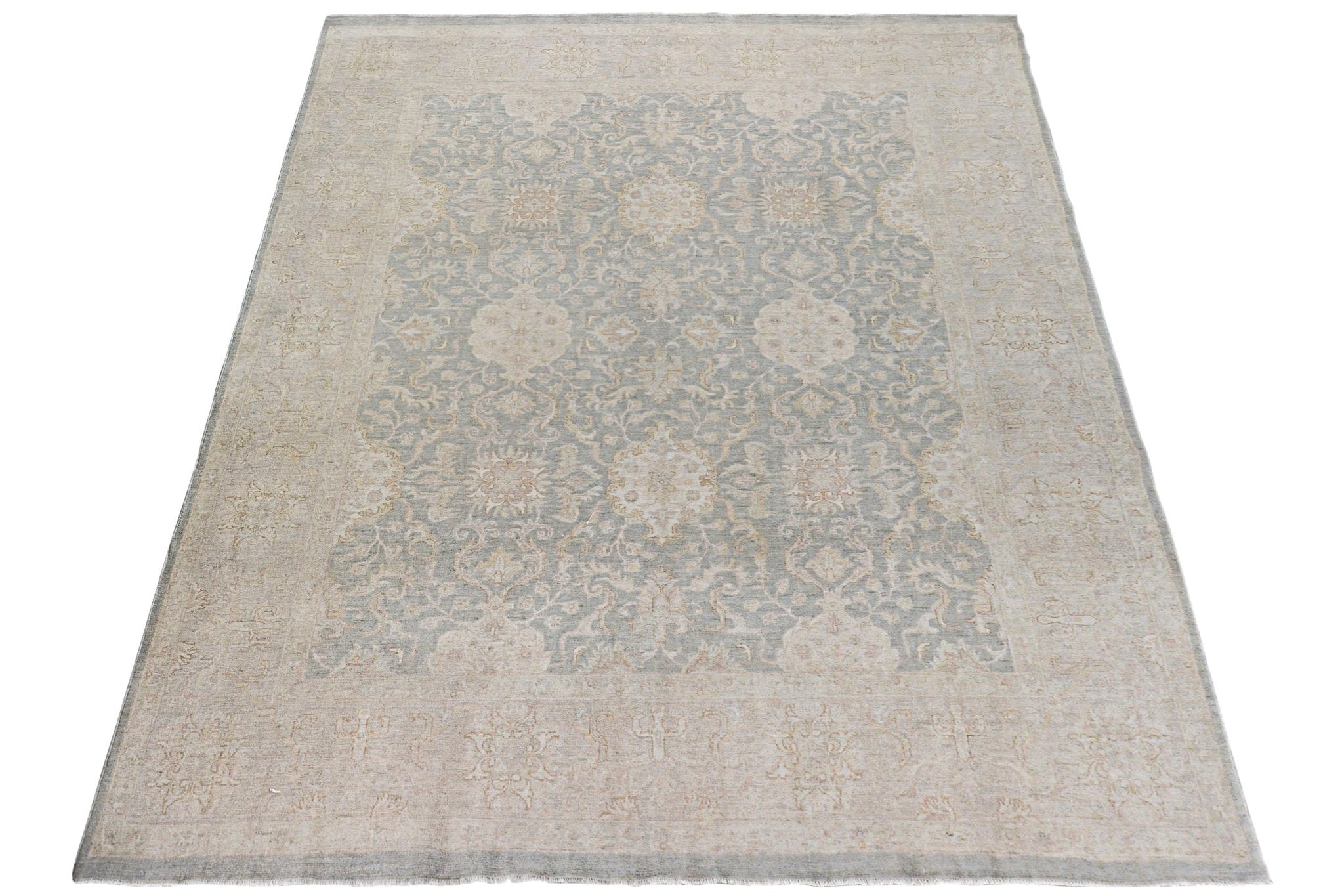 A handmade Afghan Chobi rug featuring a traditional floral pattern in soft blue and beige tones.