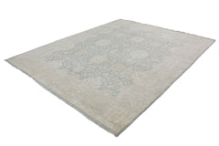 An Afghan Chobi rug featuring a traditional floral pattern in soft blue and beige tones.