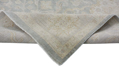 A handmade Afghan Chobi rug featuring a traditional floral pattern in soft blue and beige tones.