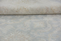 A handmade Afghan Chobi rug featuring a traditional floral pattern in soft blue and beige tones.