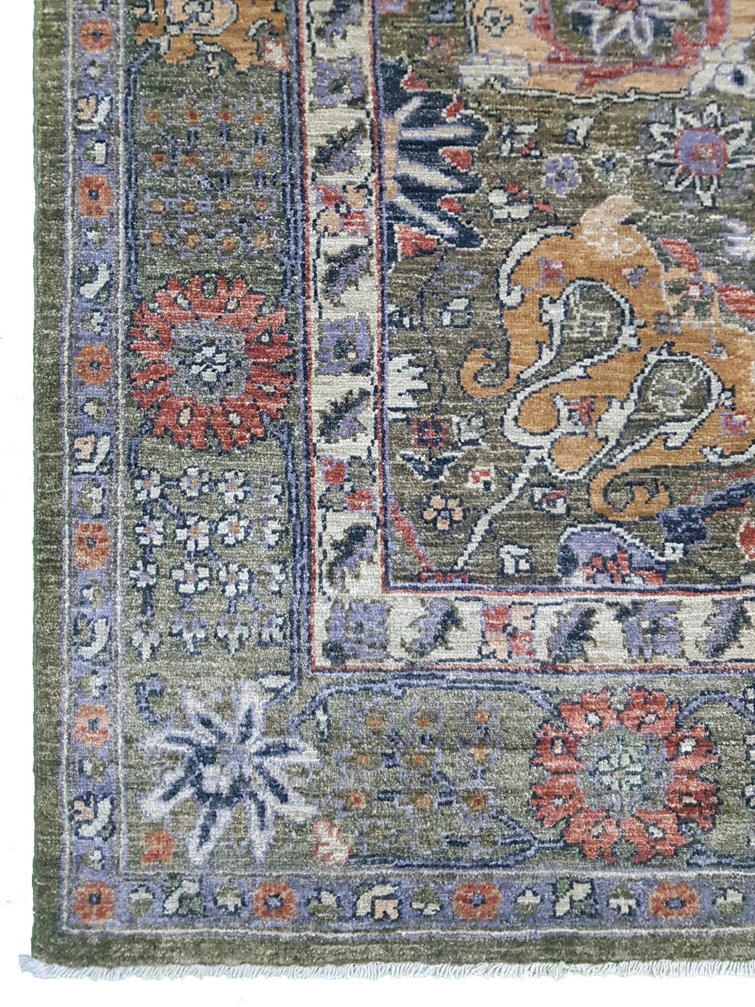 A handwoven Afghan Chobi rug featuring intricate floral patterns in earthy tones on a green field.