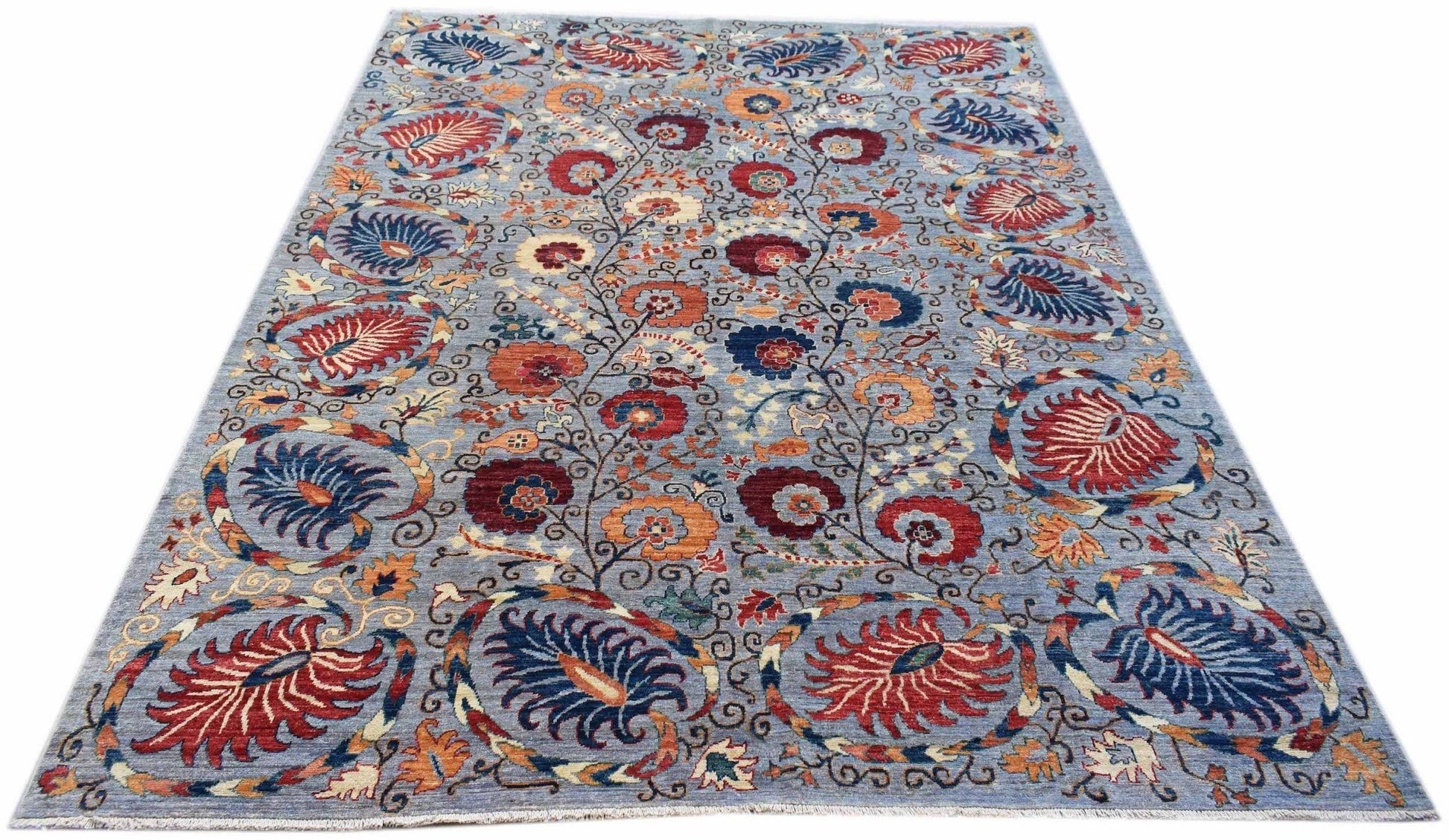An Afghan Chobi rug featuring a traditional floral pattern in red and blue on a light blue field.
