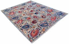 A handwoven Afghan Chobi rug featuring a floral pattern in red and blue on a light grey background.