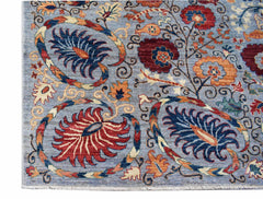 An Afghan Chobi rug featuring intricate floral patterns in red, blue, and orange on a blue field.