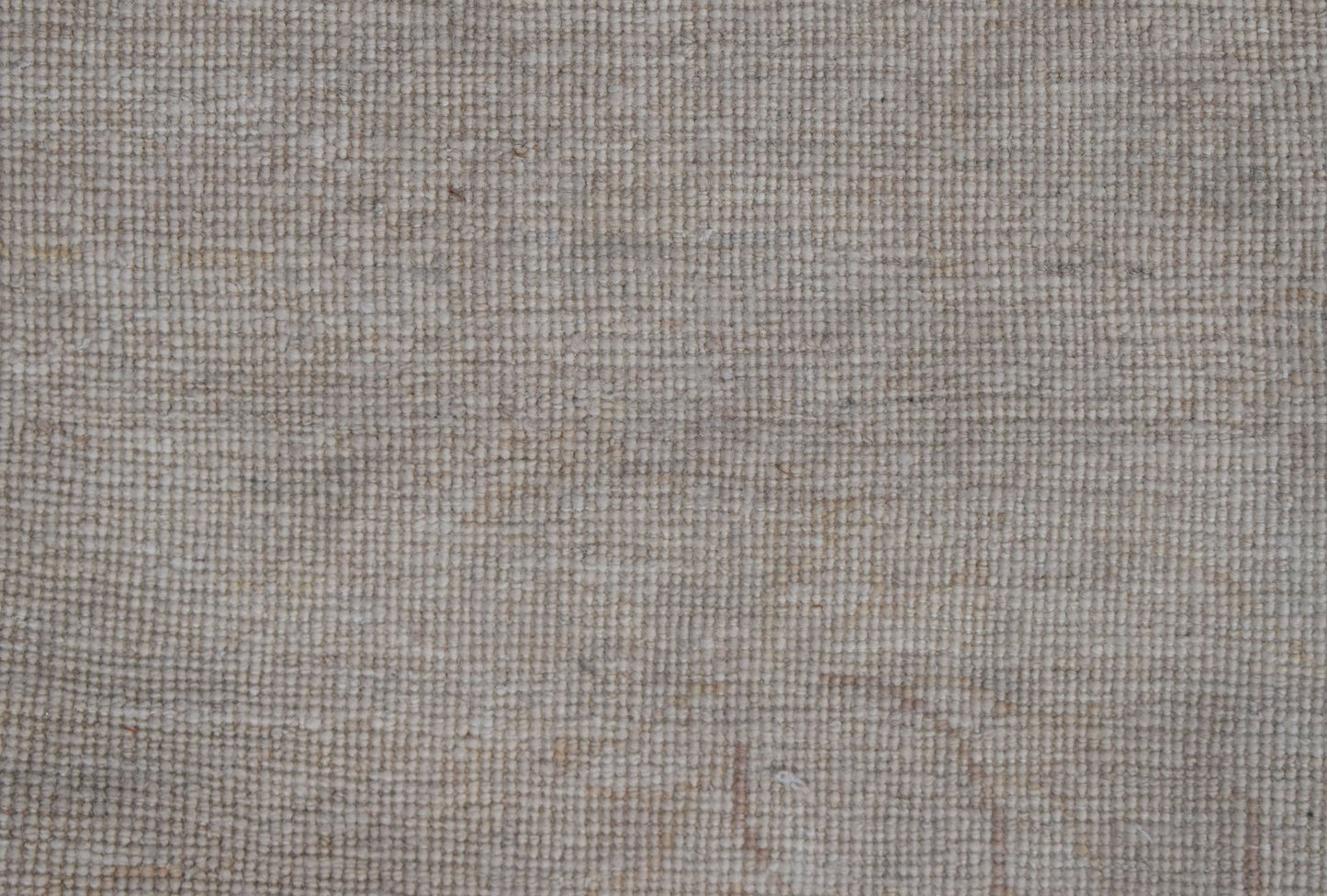 A close-up view of a handwoven Afghan Chobi rug featuring a textured, neutral-toned wool weave.