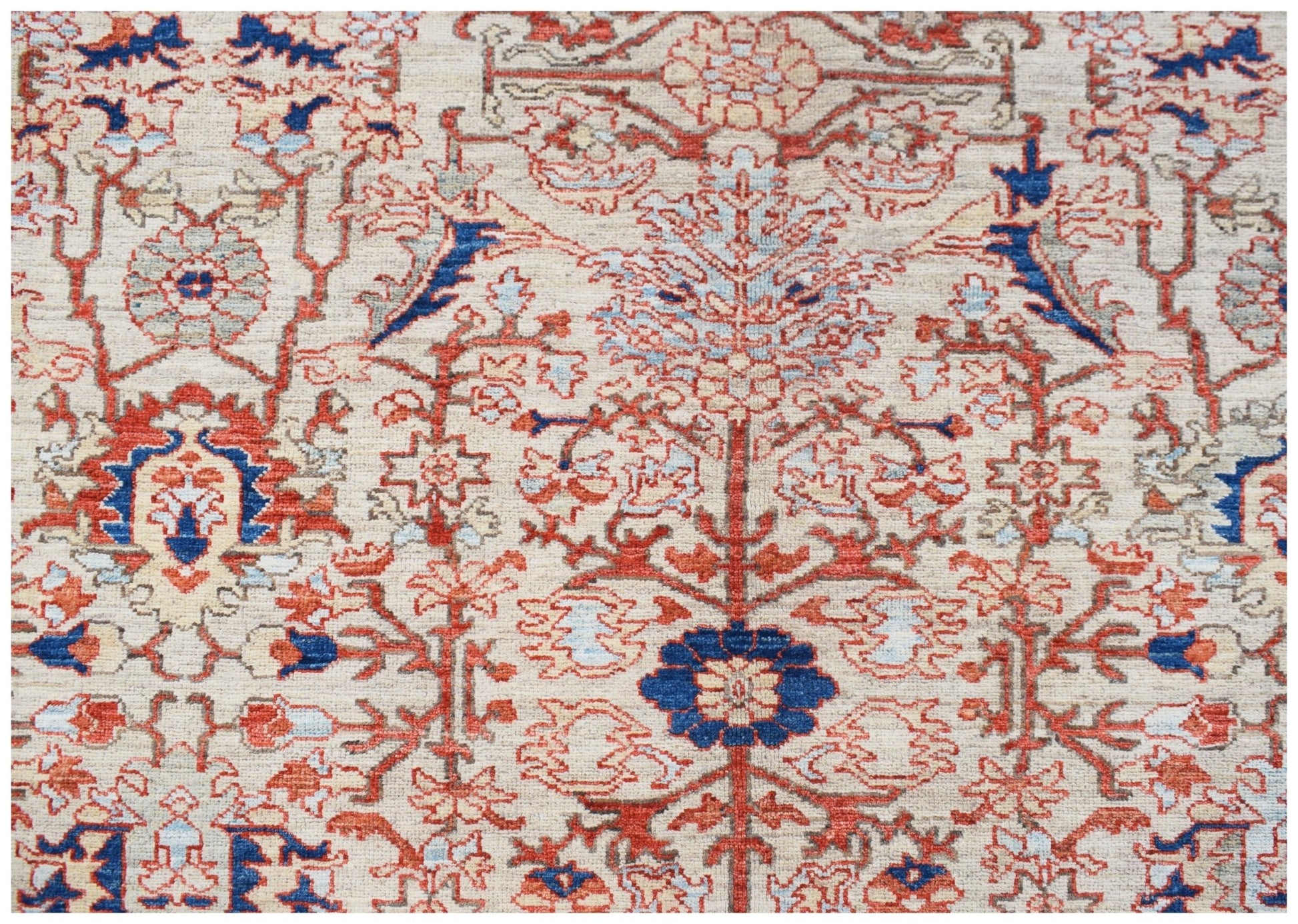 Handwoven Afghan Chobi rug featuring a traditional floral pattern in red, blue, and cream tones.