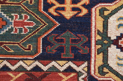 A close-up of a handwoven Afghan Chobi rug featuring intricate geometric patterns in earthy tones.
