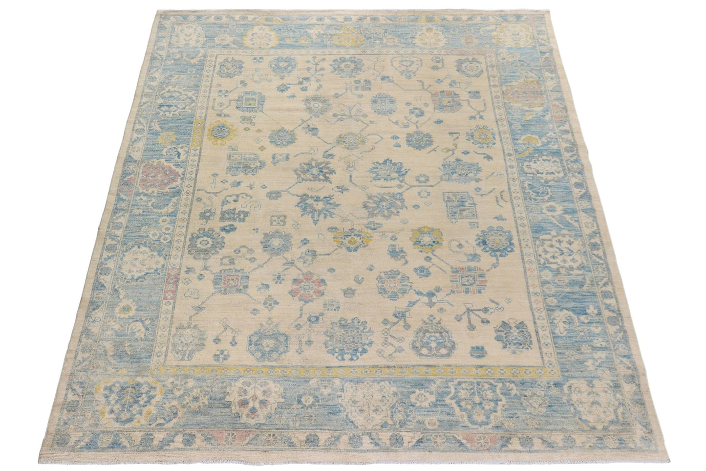 Handmade Afghan Chobi rug featuring a traditional floral pattern in blue, yellow, and cream tones.