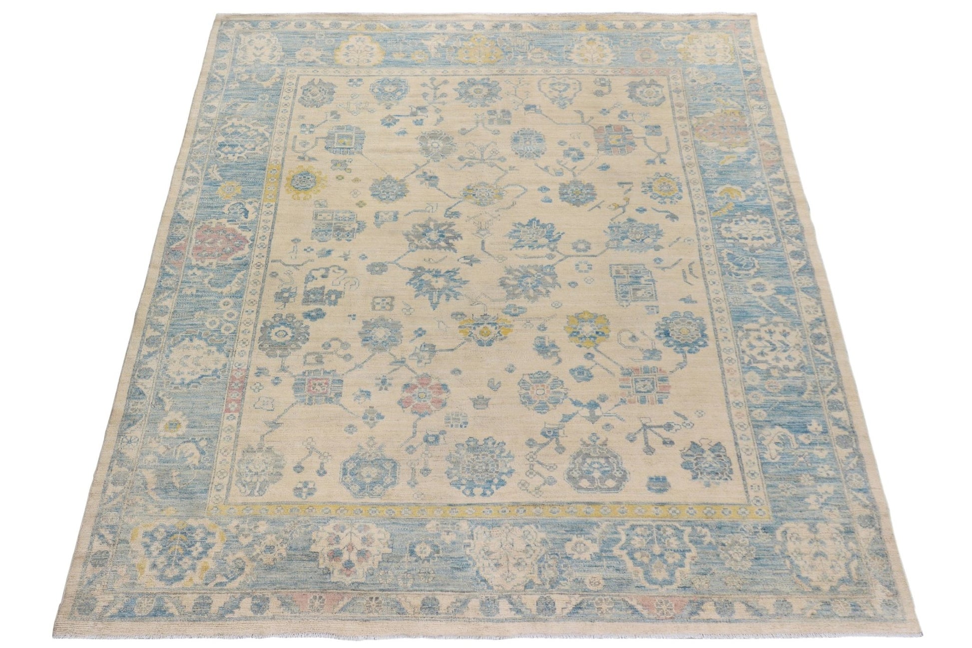 Handmade Afghan Chobi rug featuring a traditional floral pattern in blue, yellow, and cream tones.