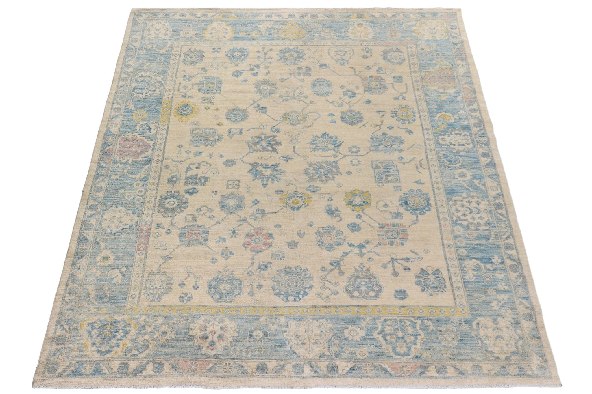 Handmade Afghan Chobi rug featuring a traditional floral pattern in blue, yellow, and cream tones.