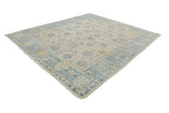 An Afghan Chobi rug featuring a traditional floral pattern in shades of blue, yellow, and cream.