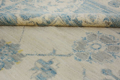 A handmade Afghan Chobi rug featuring a traditional floral pattern in blue and cream tones.