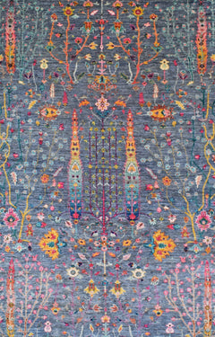 A handmade Afghan Chobi rug featuring a floral pattern in vibrant colors on a blue background.