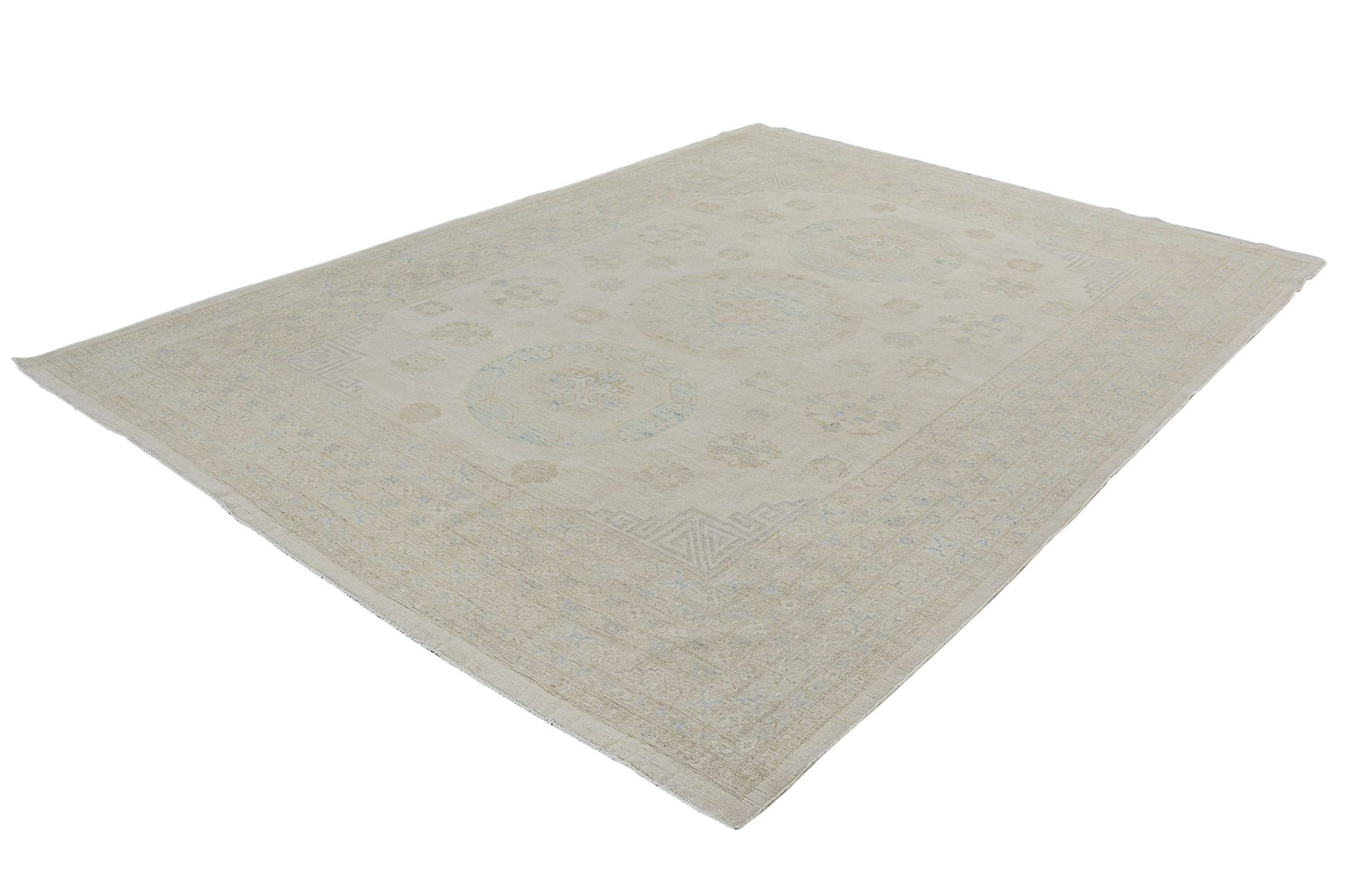 An Afghan Chobi rug featuring a traditional medallion pattern in soft beige and blue tones.