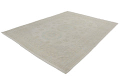 An Afghan Chobi rug featuring a traditional medallion pattern in soft beige and blue tones.