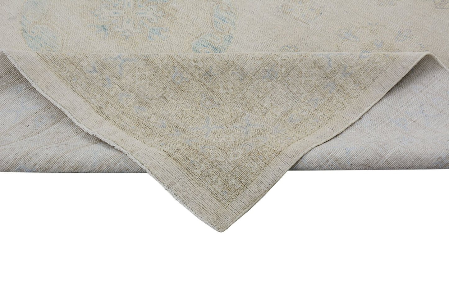 An Afghan Chobi rug with a light beige background and soft blue floral patterns.