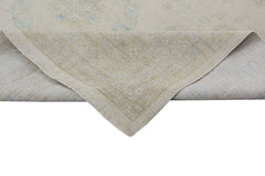 An Afghan Chobi rug with a light beige background and soft blue floral patterns.