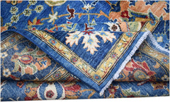 A handwoven Afghan Chobi rug featuring a traditional floral pattern in blue, red, and gold tones.