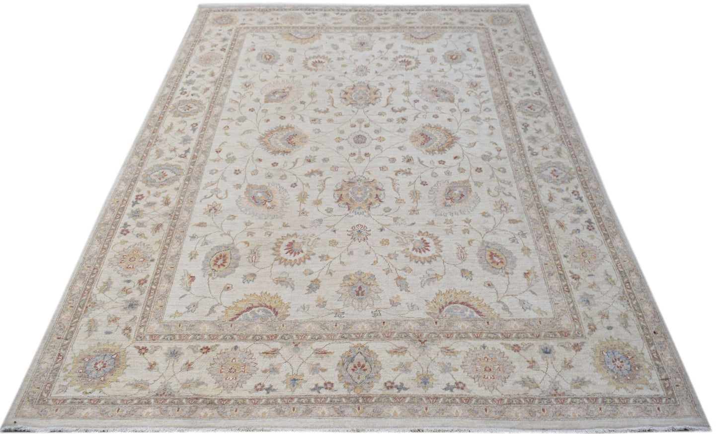 An Afghan Chobi rug featuring a traditional floral pattern in soft, earthy tones.