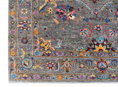 An Afghan Chobi rug featuring a grey field with intricate, colorful floral and vine patterns.