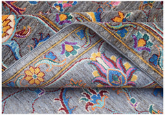 A handwoven Afghan Chobi rug featuring a traditional floral pattern in vibrant, multi-colored wool.