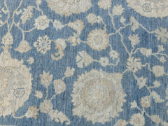 An Afghan Chobi rug featuring a traditional floral pattern in shades of blue and cream.