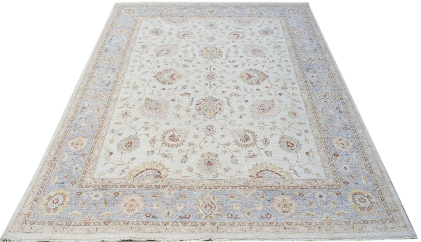 A handmade Afghan Chobi rug featuring a traditional floral pattern in soft, neutral tones.
