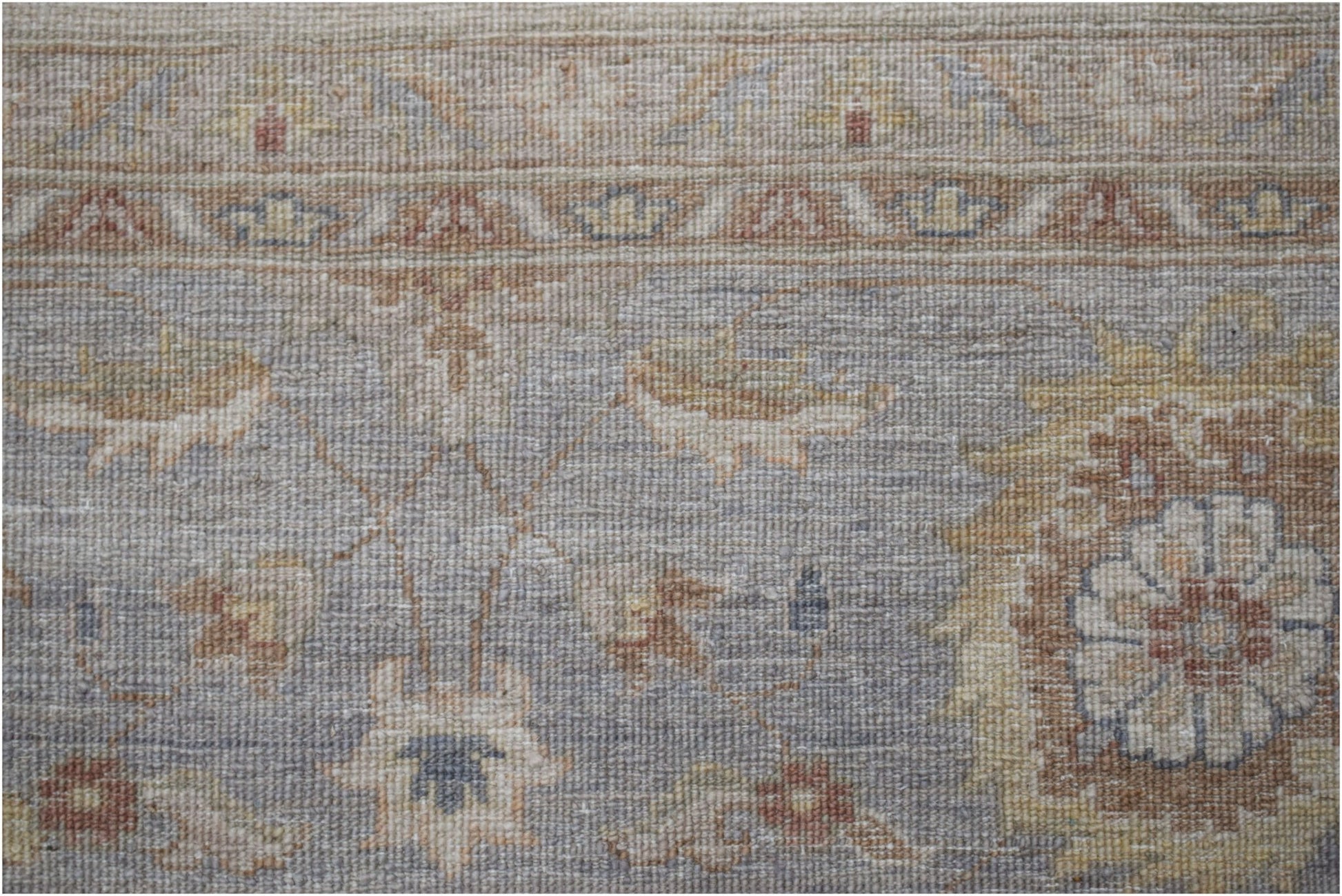 A handwoven Afghan Chobi rug featuring a traditional floral pattern in muted earth tones.
