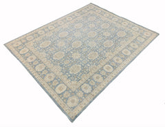 A handmade Afghan Chobi rug featuring a traditional floral pattern in soft blue and beige tones.