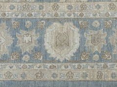 A handmade Afghan Chobi rug featuring a traditional floral pattern in soft blue and beige tones.