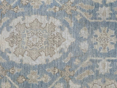 A handmade Afghan Chobi rug featuring a traditional floral medallion pattern in blue and beige.