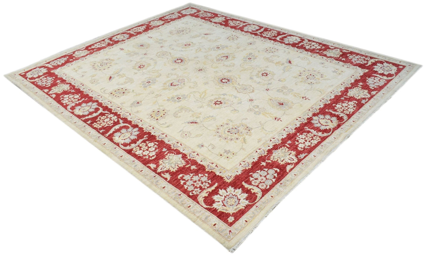 An Afghan Chobi rug featuring a cream field with floral patterns and a wide red border.