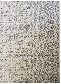 Handmade Afghan Chobi rug featuring a traditional dark brown floral pattern on a beige wool base.