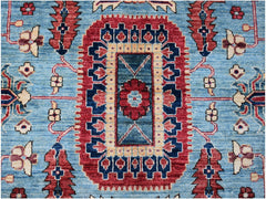 An Afghan Chobi rug featuring a central floral medallion on a blue field with red geometric borders.