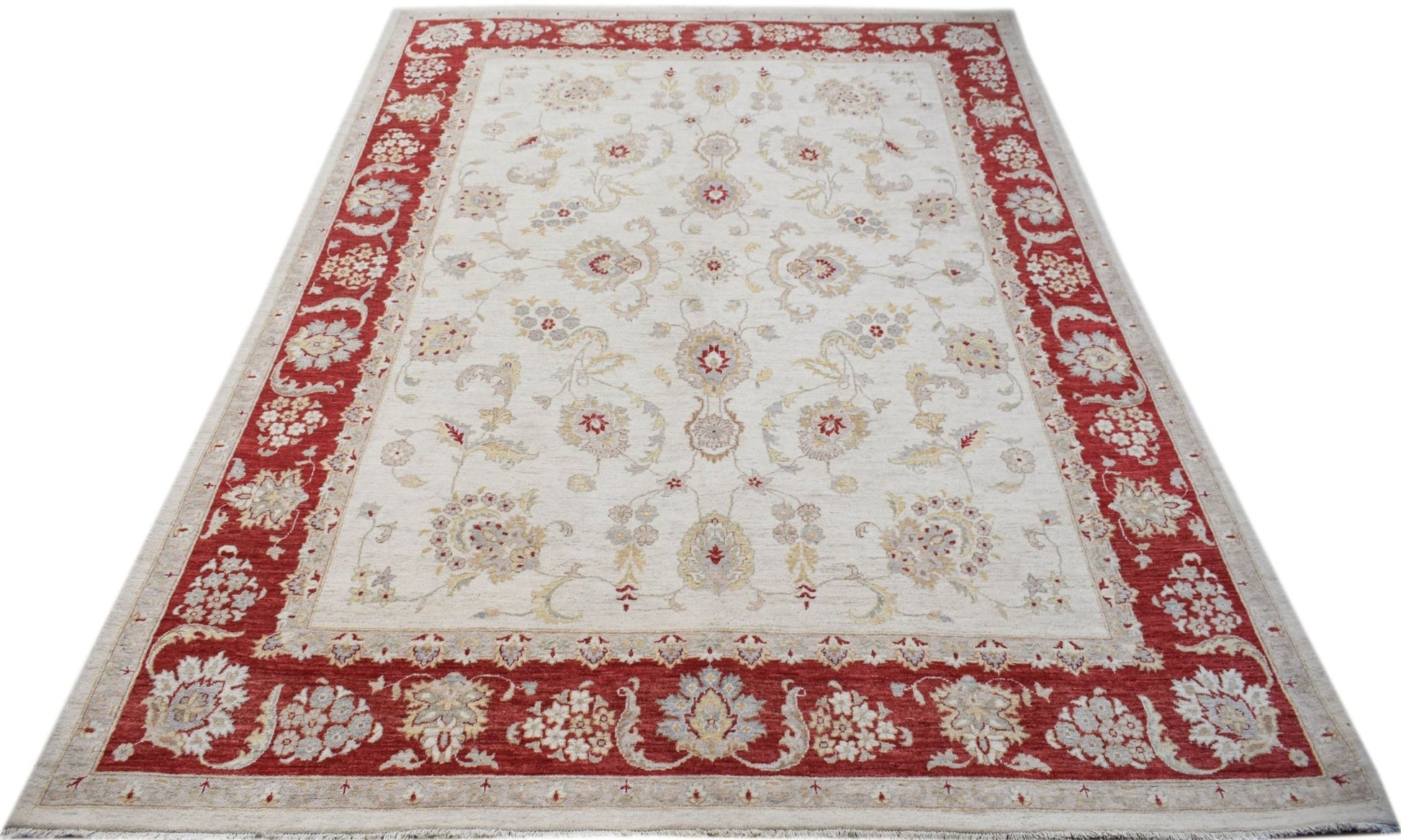 An Afghan Chobi rug featuring a cream field with floral motifs and a wide red border.