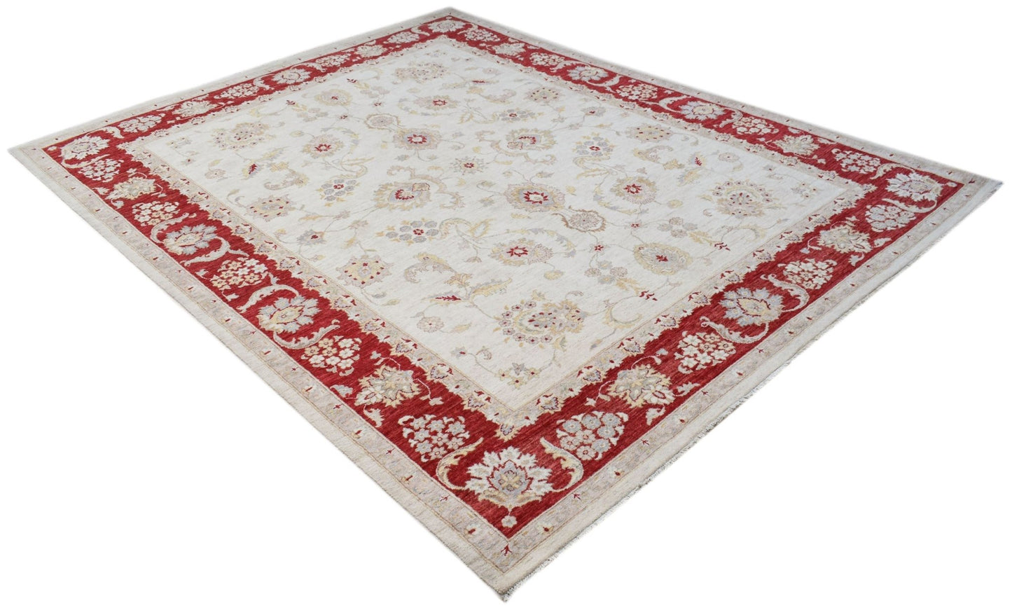 An Afghan Chobi rug featuring a cream field with floral motifs and a wide red border.