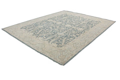 A handmade Afghan Chobi rug featuring a traditional floral pattern in blue and beige tones.