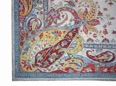 A corner view of a handwoven Afghan Chobi rug featuring a traditional paisley pattern in vibrant colors.