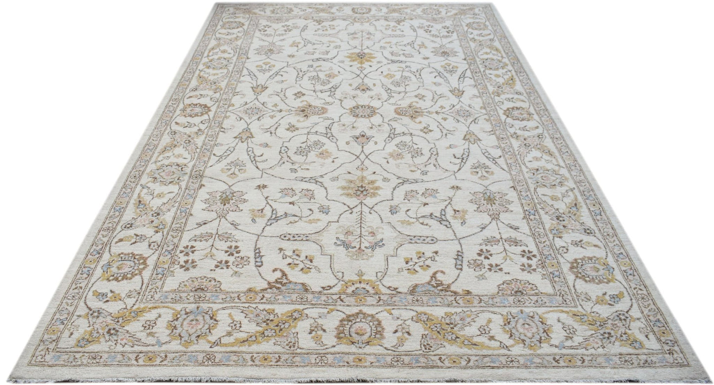An Afghan Chobi rug featuring a traditional floral pattern in soft, earthy tones on a cream base.