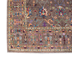 A handwoven Afghan Chobi rug featuring intricate floral patterns in earthy tones on a brown field.