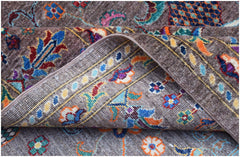 A handwoven Afghan Chobi rug featuring a traditional floral pattern in vibrant, earthy tones.