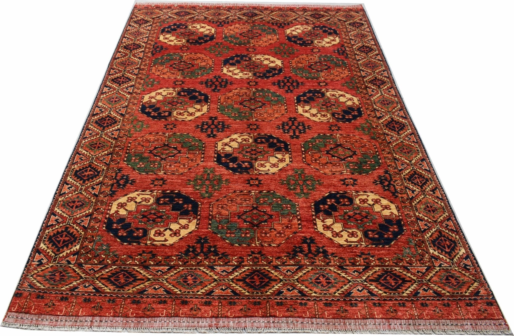 A handmade Afghan Chobi rug featuring a repeating octagonal pattern in warm, earthy tones.