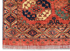 A handwoven Afghan Chobi rug featuring traditional geometric patterns in red, blue, and cream.