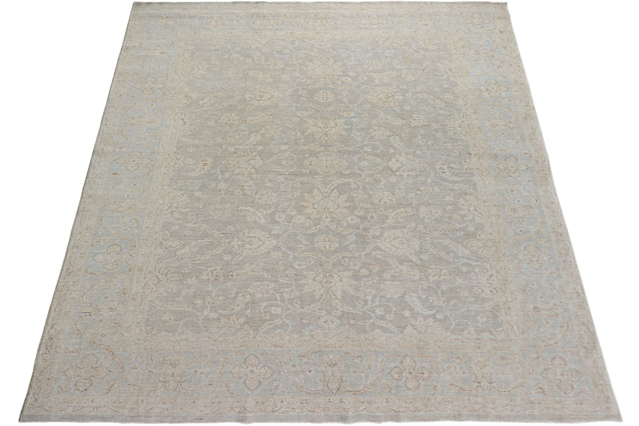 A handmade Afghan Chobi rug featuring a traditional floral pattern in soft beige and grey tones.