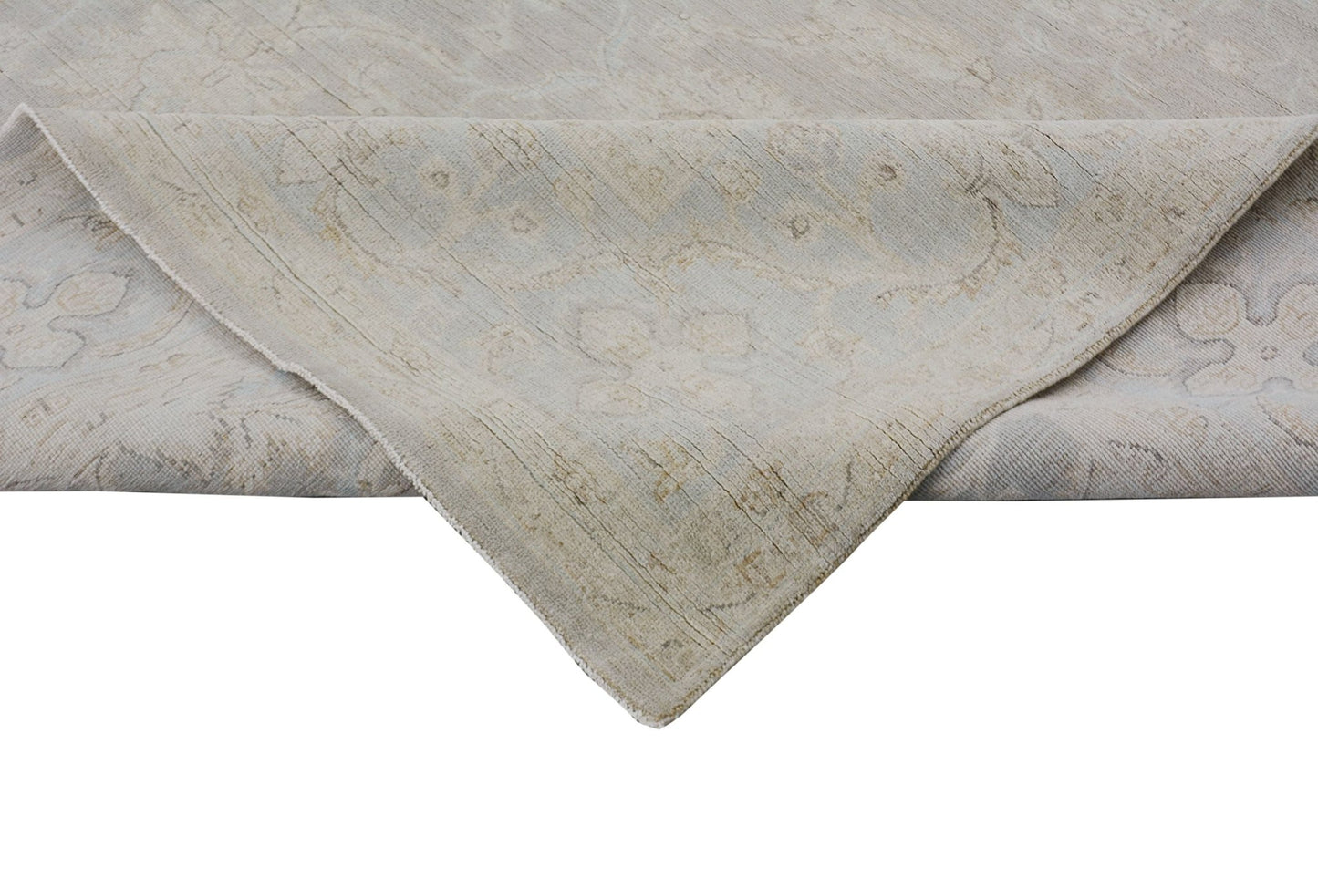 A handmade Afghan Chobi rug featuring a traditional floral pattern in soft, neutral wood tones.
