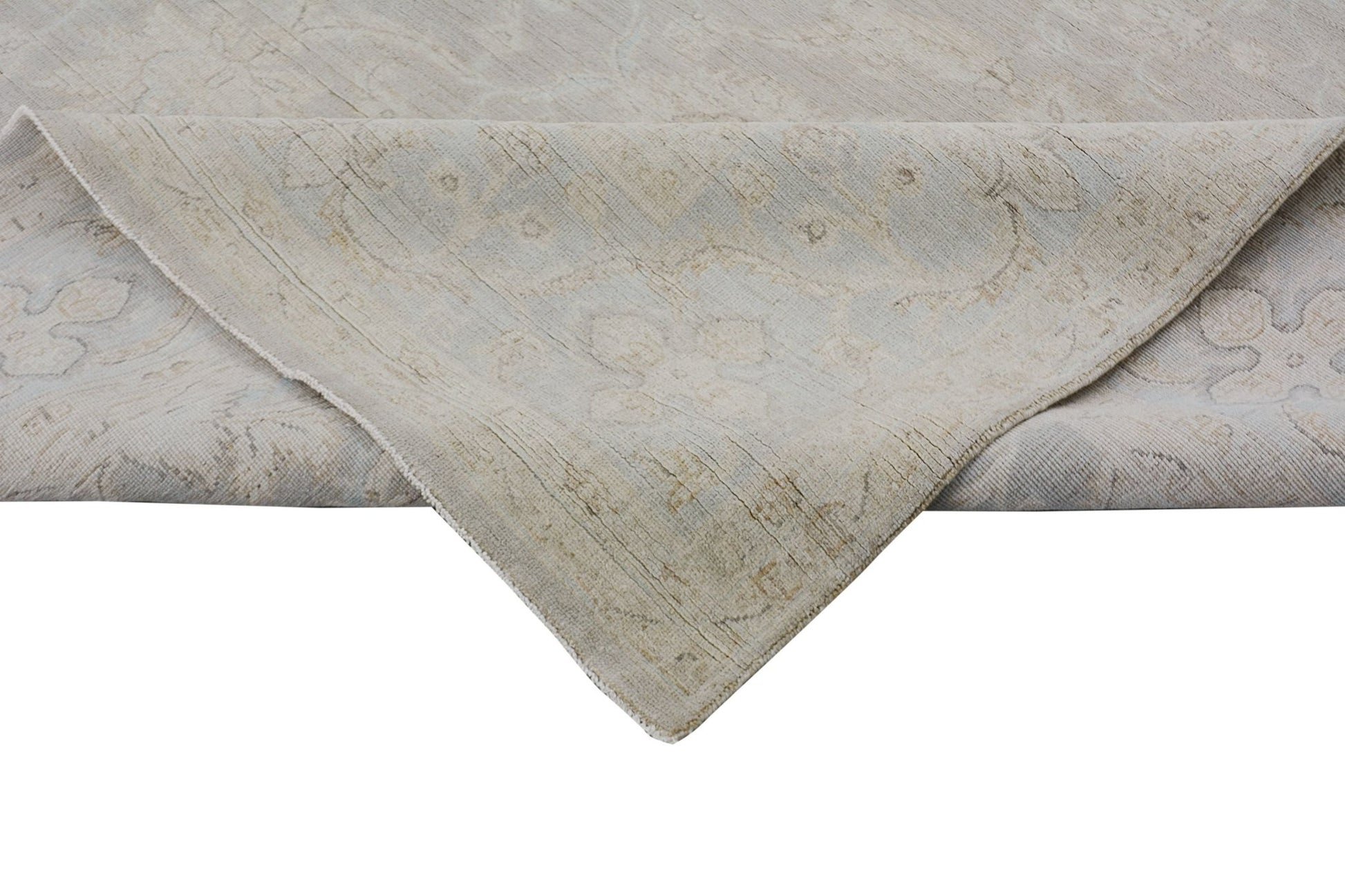 A handmade Afghan Chobi rug featuring a traditional floral pattern in soft, neutral wood tones.