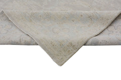 A handmade Afghan Chobi rug featuring a traditional floral pattern in soft, neutral wood tones.